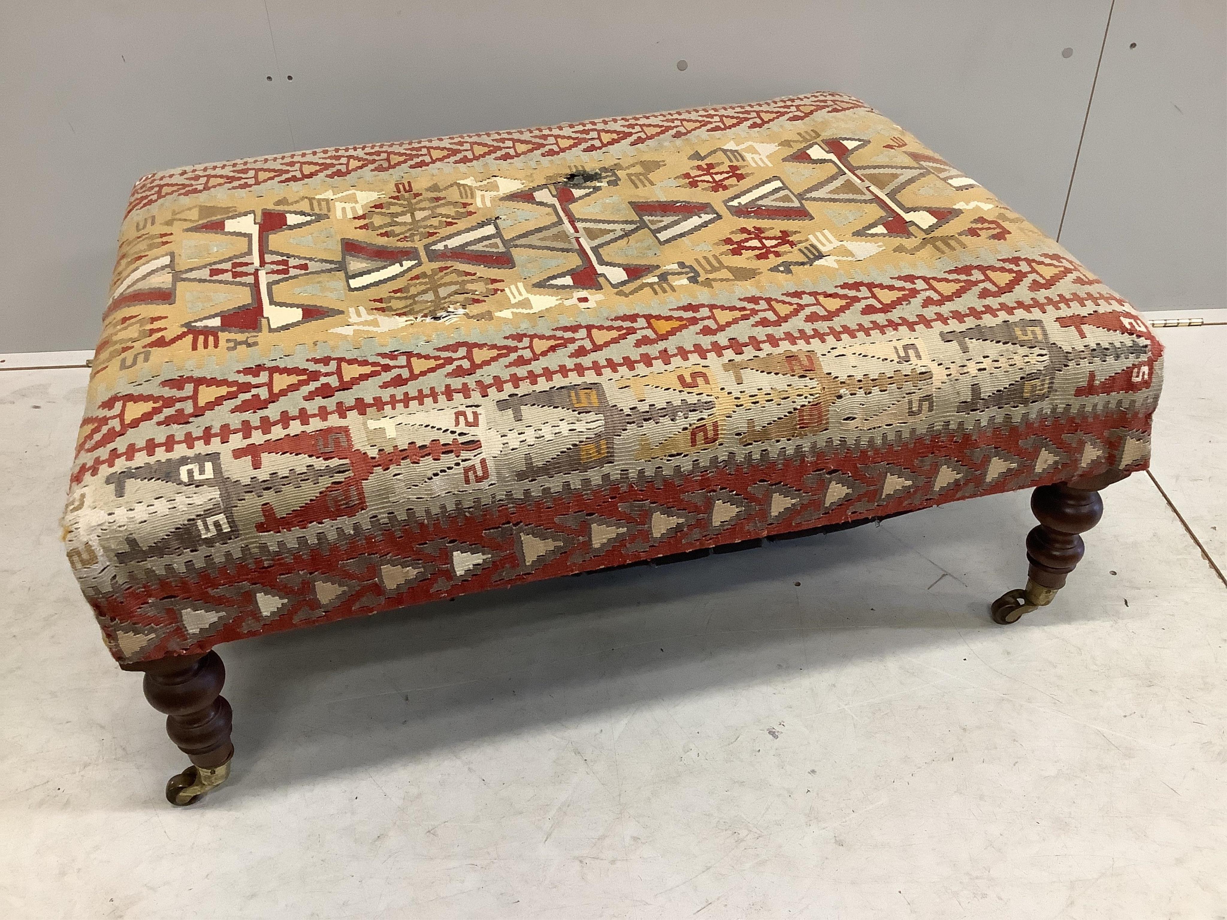 A rectangular Victorian style footstool with Kilim upholstery, width 102cm, depth 76cm, height 41cm. Condition - poor to fair